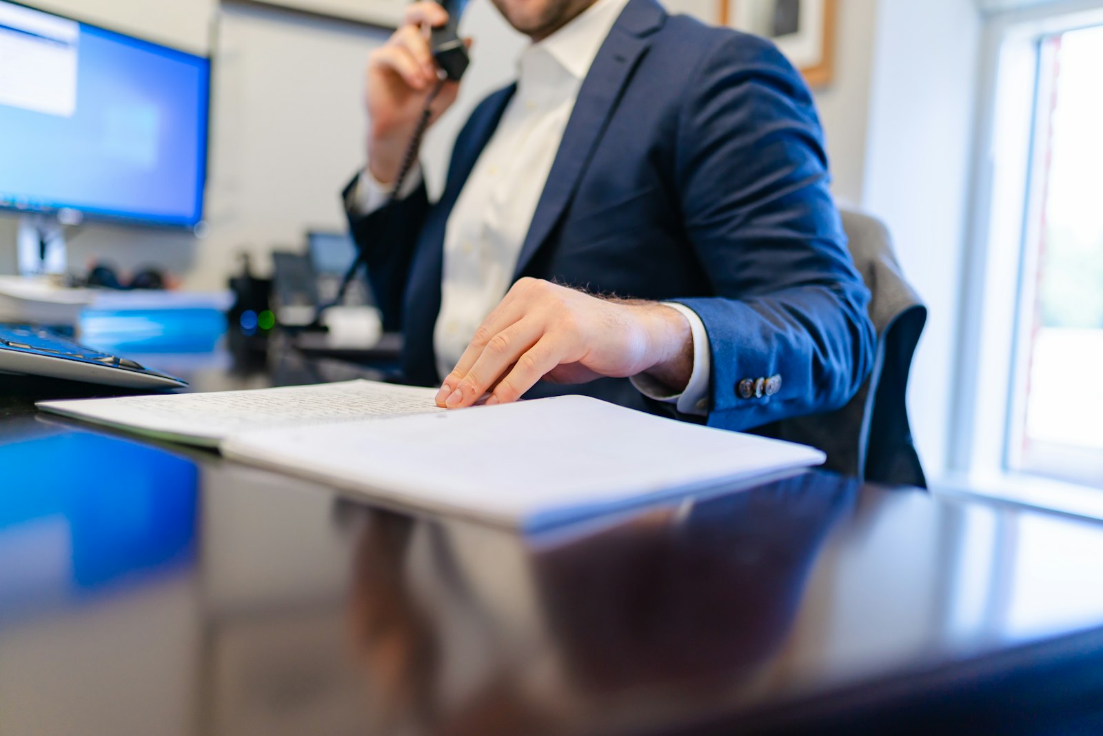 An insurance broker reviewing an account portfolio at a desk